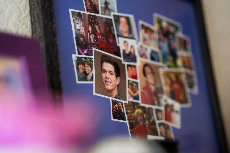 A collage of various candid photos arranged in a heart shape, displayed in a frame. The images feature people of different ages smiling, posing, and interacting, with one prominent portrait in the center. The background is a soft blur, focusing on the collage.