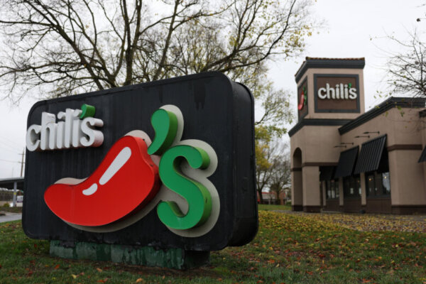 A sign is posted in front of a Chili's restaurant.