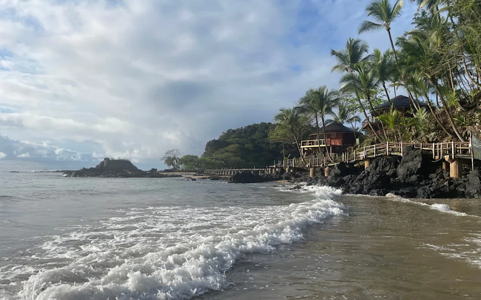 Waves crashing along the beach at Bom Bom Island Resort in Príncipe