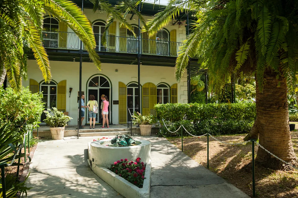 Key West, USA - March 18, 2013: Ernest Hemingway's house  in Key West, Florida, USA. Tree tourists entering the home..