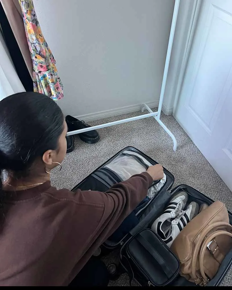 Someone packing carry on luggage.