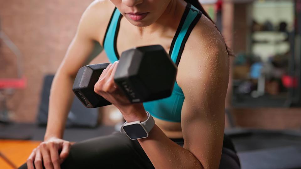  A woman doing a dumbbell bicep curl. 