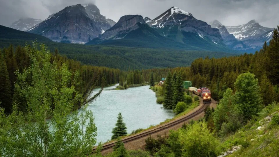 Train passing through Morants Curve in bow valley, Banff National Park