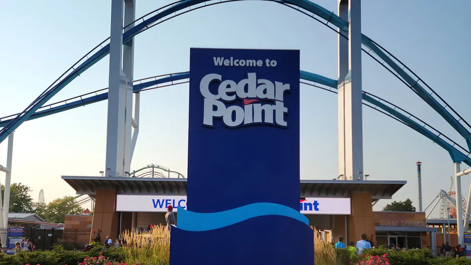 Sandusky, OH, USA - August 20, 2021: The entrance of Cedar Point with the Gatekeeper ride over the top in the evening with a sunset.